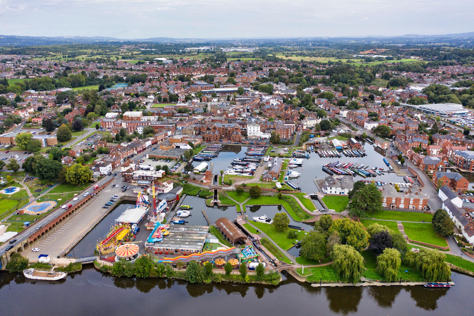 An image of Stourport Town, Stourport-on-Severn, from the air. Including The high street, river sever, tontine, Stourport Canal Basins, Treasure Island Amusements and more. Image credit Michael Whitefoot